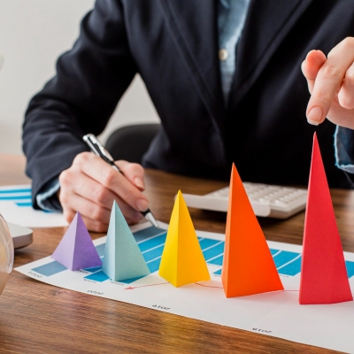 front-view-businessman-with-colorful-cones-representing-growth